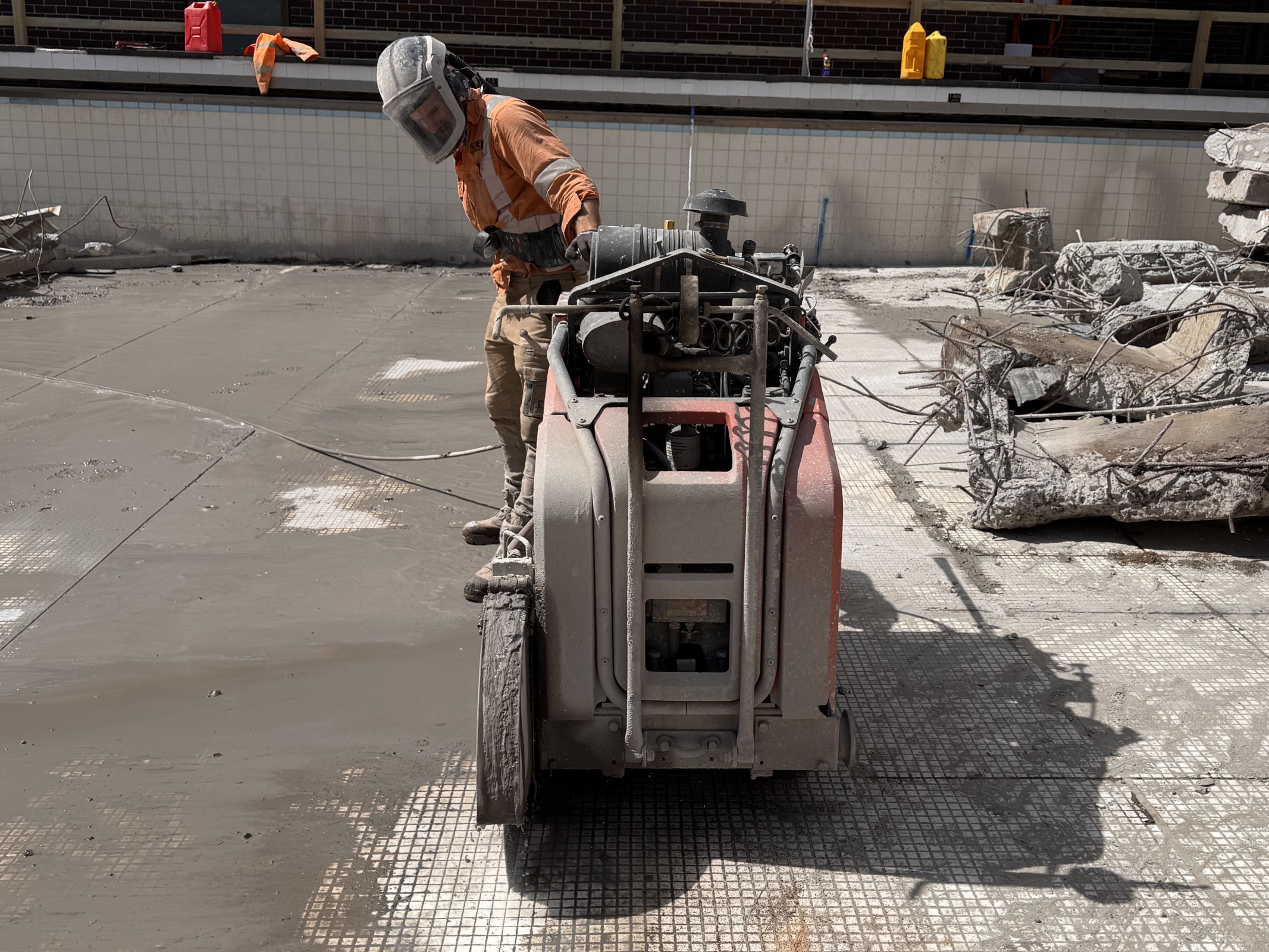 Hand sawing reinforced concrete during the Scots College pool redevelopment