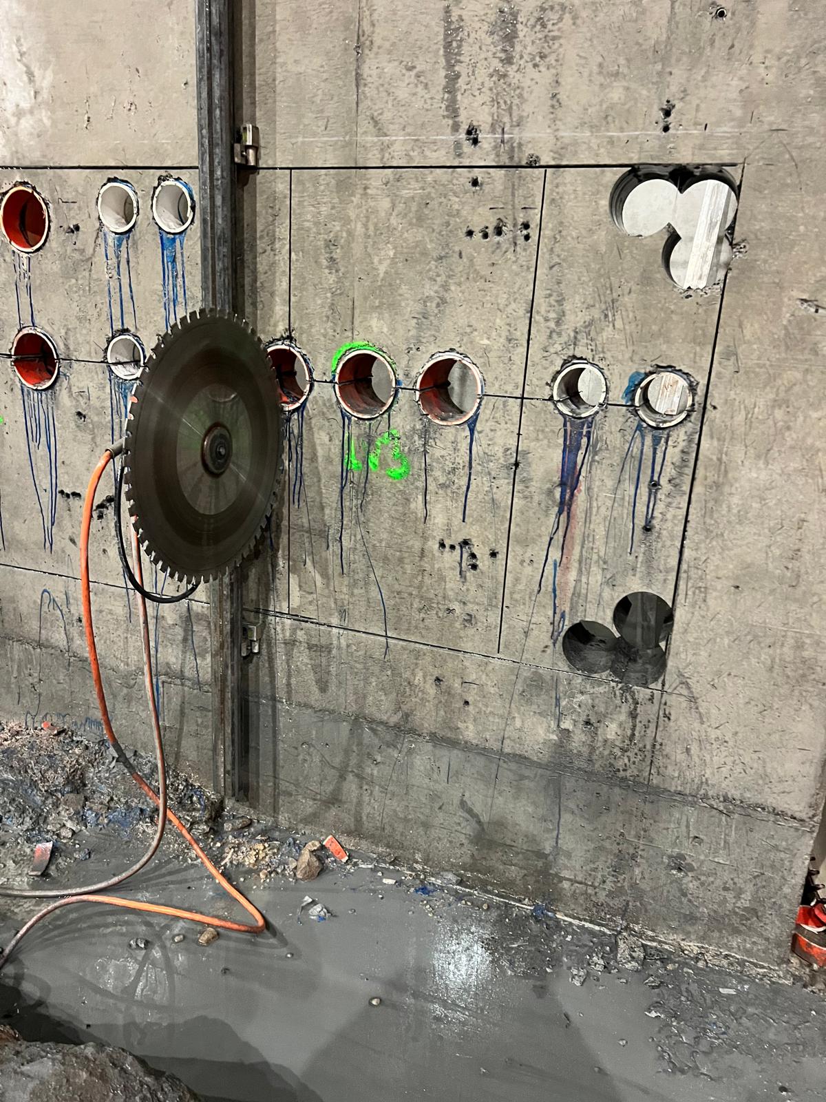 ALL CORE wall saw completing a controlled concrete cut